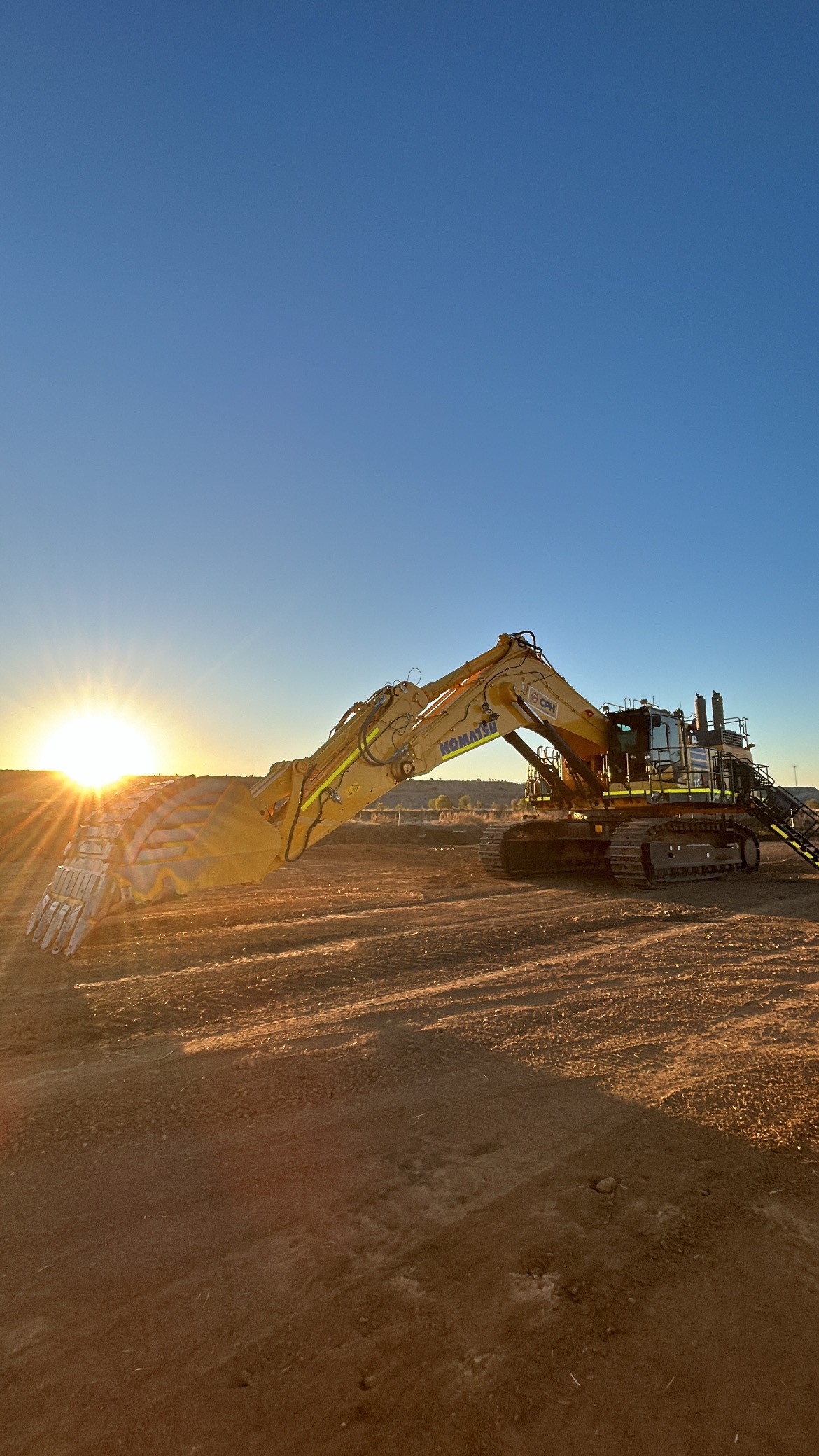 Komatsu excavator at golden hour